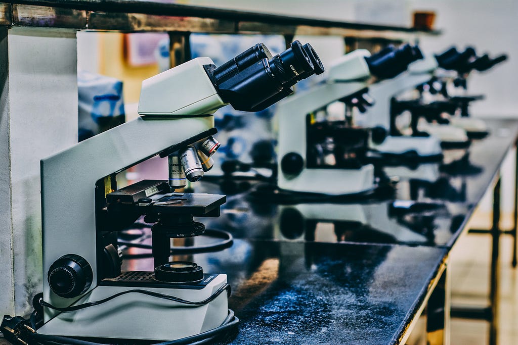 White microscopes on black table