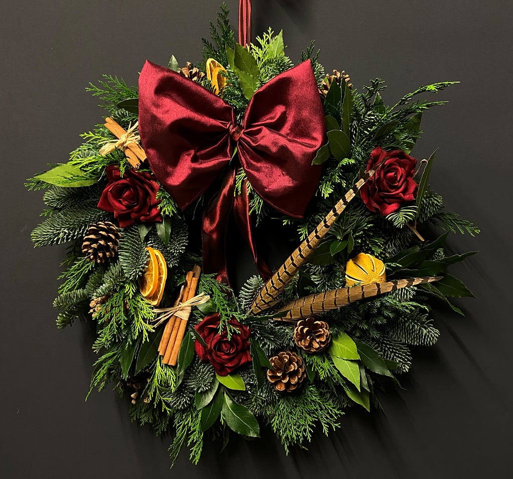 Christmas wreath with large red ribbon by Lavender Blue Florist