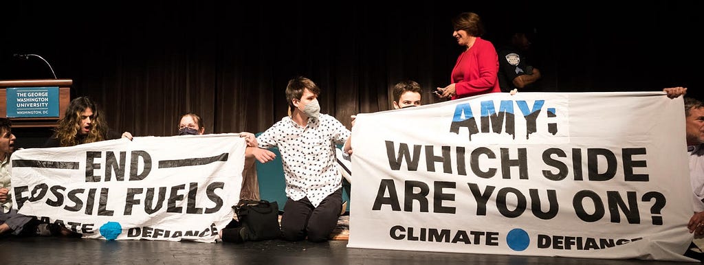 Climate Defiance protestors block stage at event with Sen. Amy Klobuchar