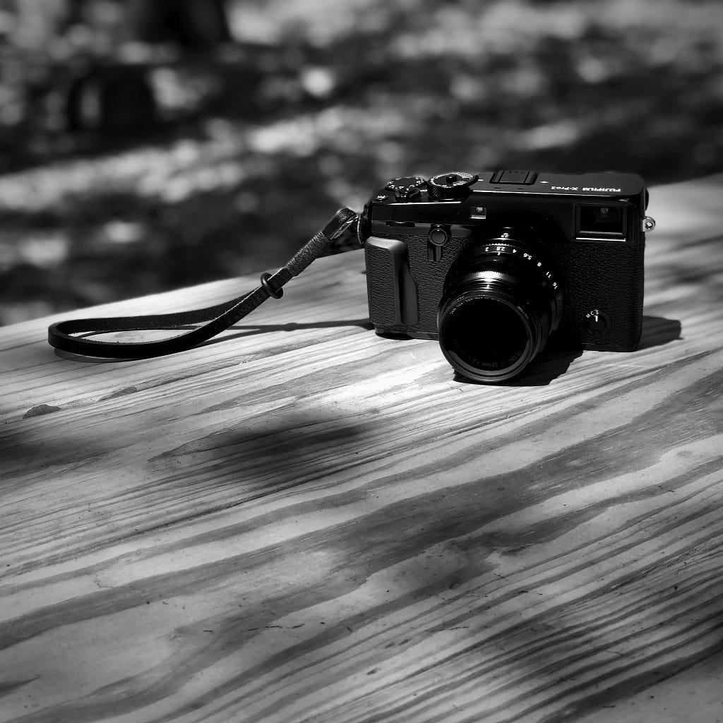 An X-Pro2 sitting on a picnic table.