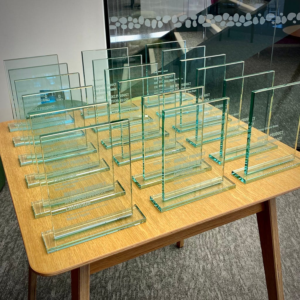 Lots of glass Which? awards on a table ready to be collected