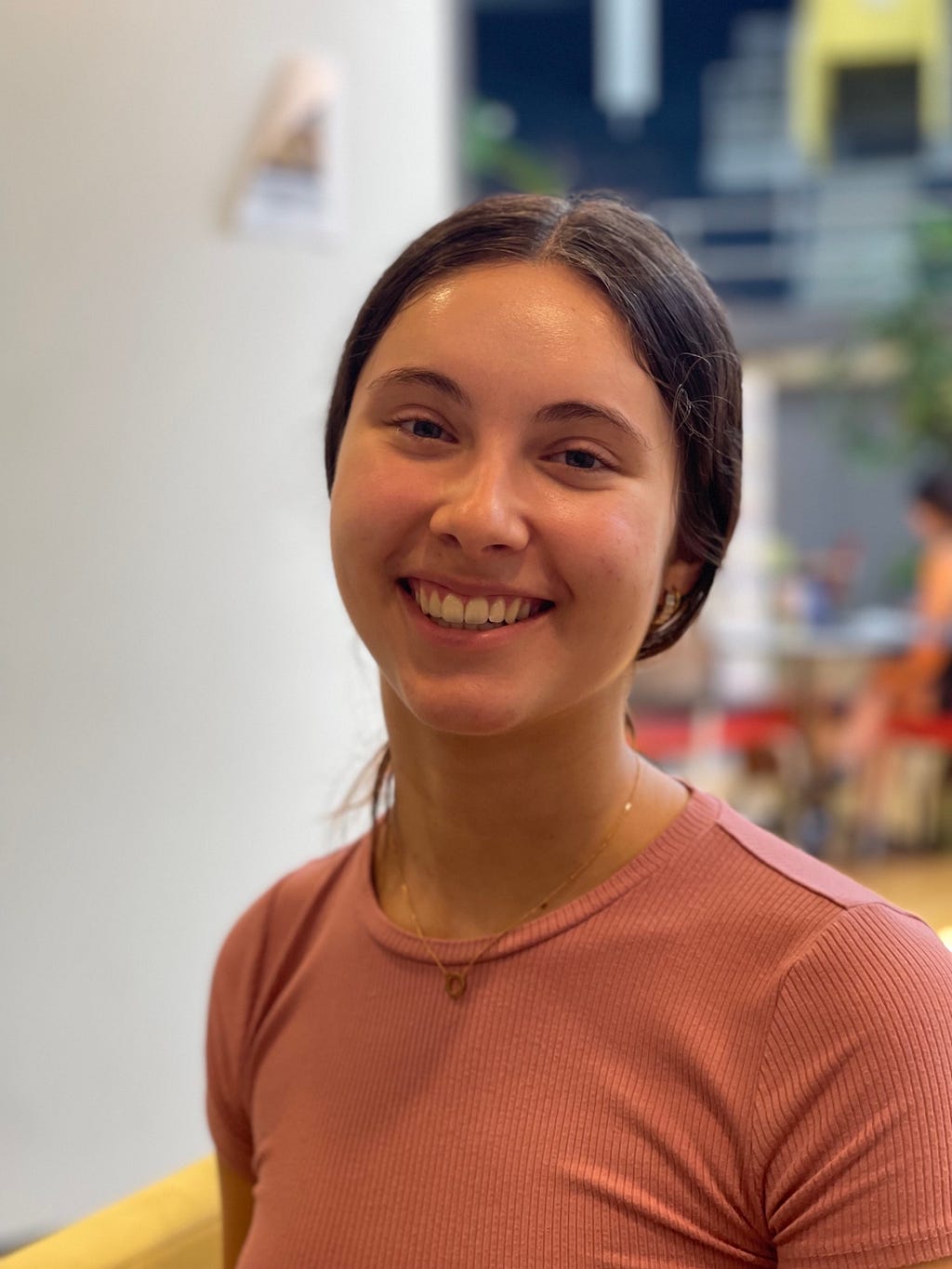 Nora Smith, junior at Saint Louis University, sitting and smiling in the Center for Global Citizenship on Saint Louis Universities’ campus on September 1st, 2022 at 10:15 am. Photo by Lauren Morby