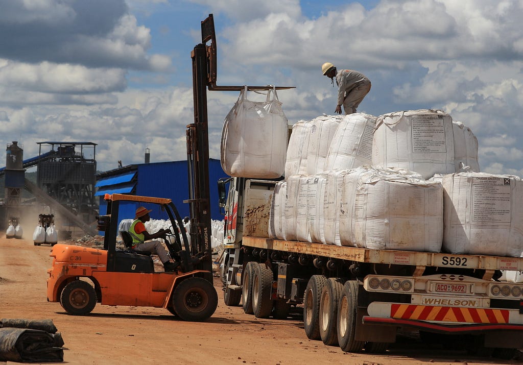 Workers load lithium concentrate at Prospect Lithium Zimbabwe mine in Goromonzi, Zimbabwe, January 9, 2024. Photo by Philimon Bulawayo/Reuters