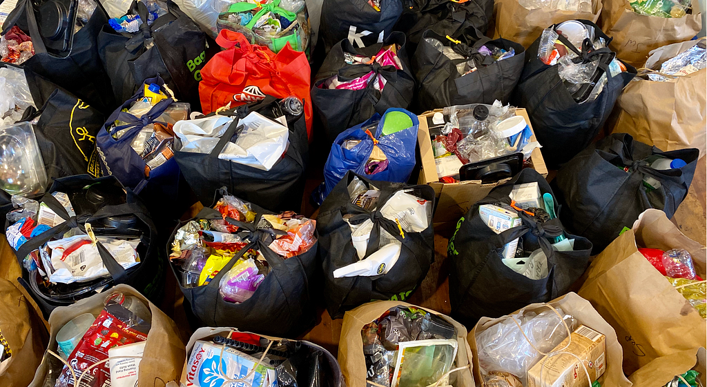 Some of the many bags of used and washed single-use plastic ready to be sorted.