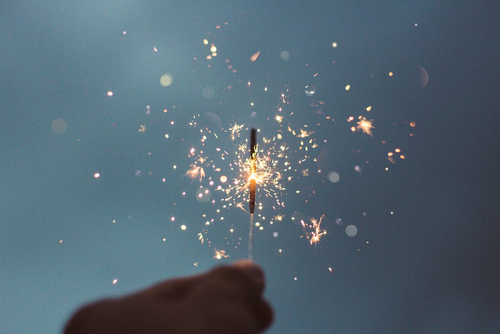 A lit-up sparkler with a flare