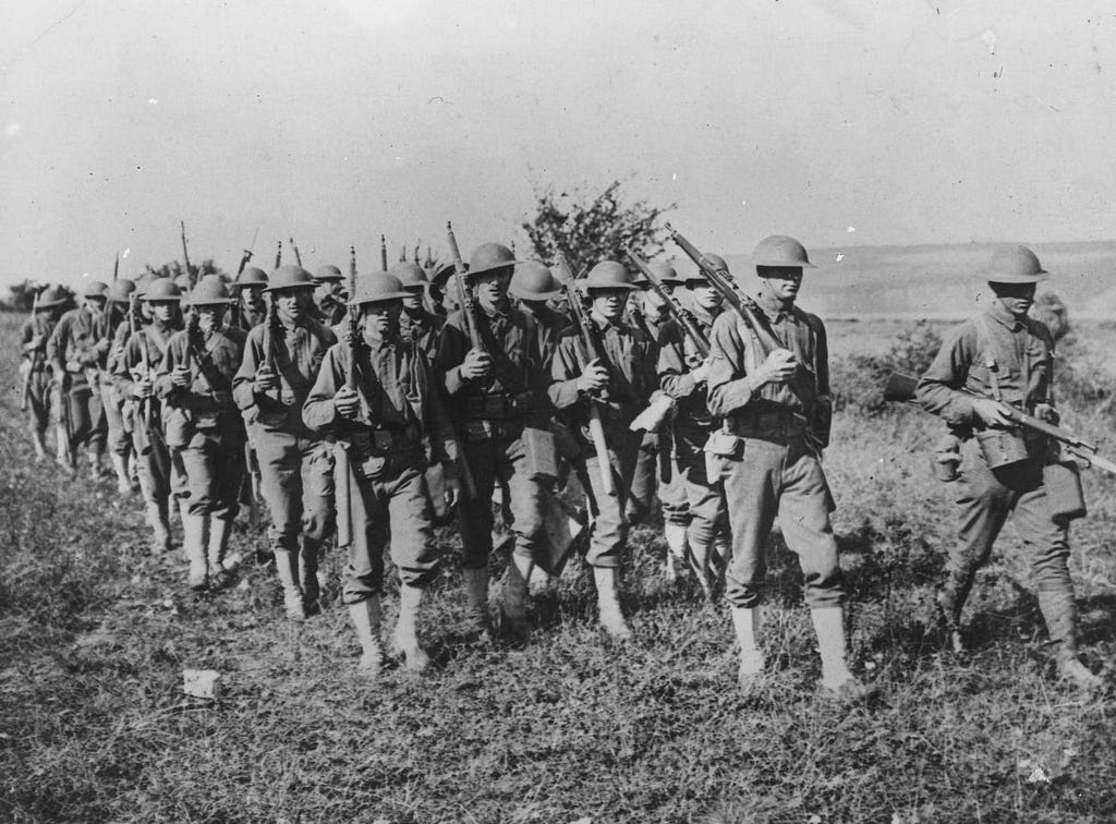 Troops are pictured marching.