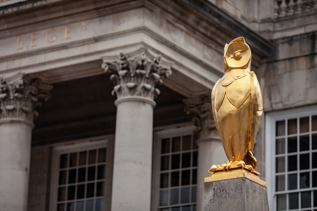 Golden owl statue in front of a historic Leeds building