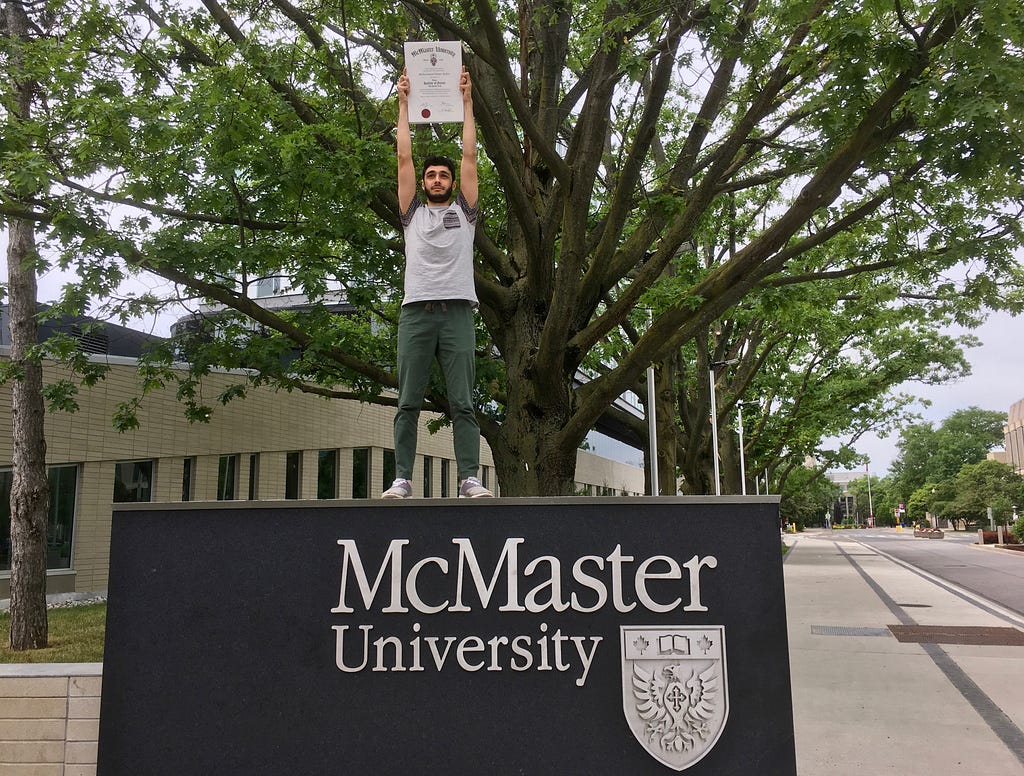 Muhammed Ebrar Aydin holding up his university degree. LegendofEbrar.