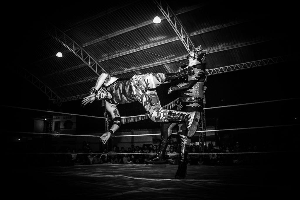 Photograph of two luchadores fighting