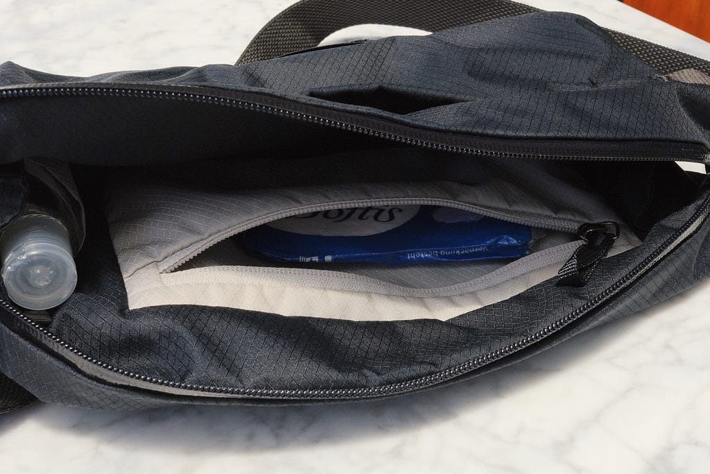 Raised pocket on the rear of the main compartment on the slate Bellroy Lite Sling