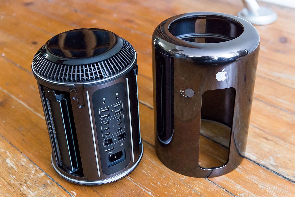 2013 Mac Pro with its case off next to the computer.