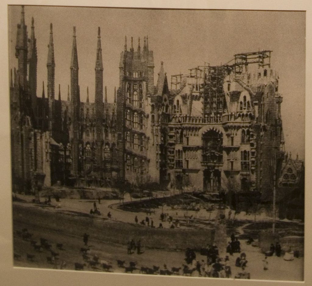 A grainy sepia photo of the Sagrada Família under construction.