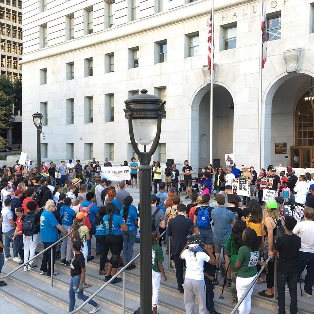 A crowd gathers outside the LA Hall of Justice at a rally supporting the families of victims of police violence