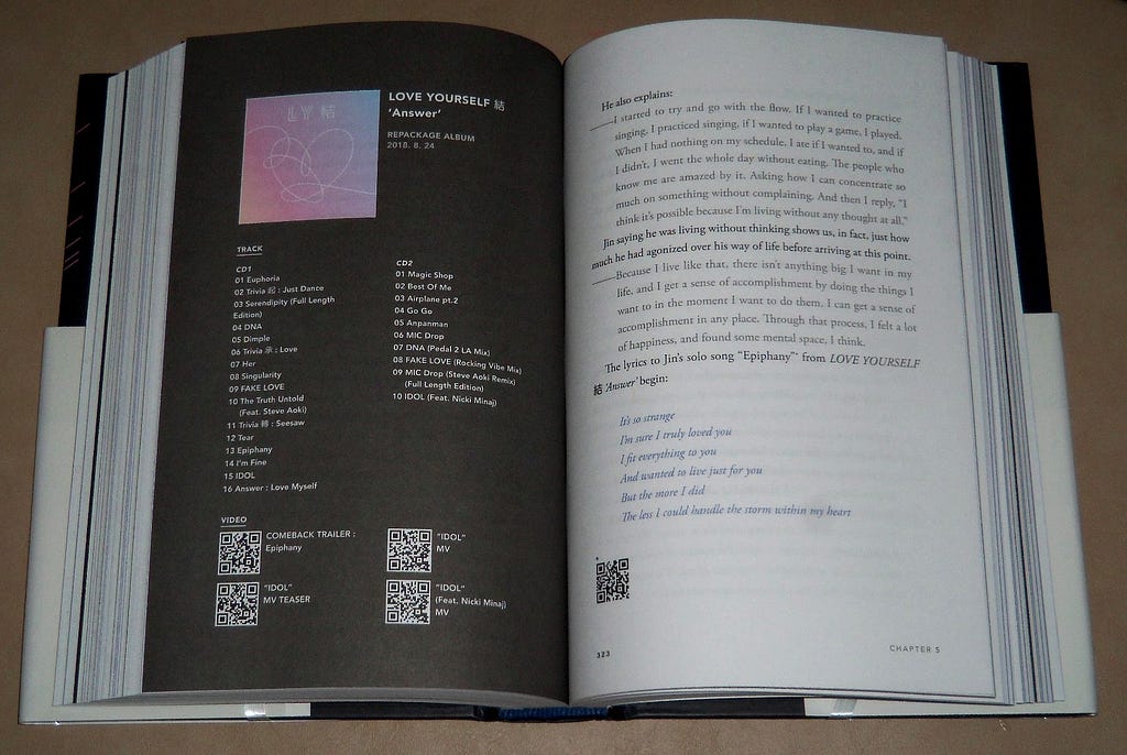 BTS book open to an album overview page for Love Yourself “Answer”