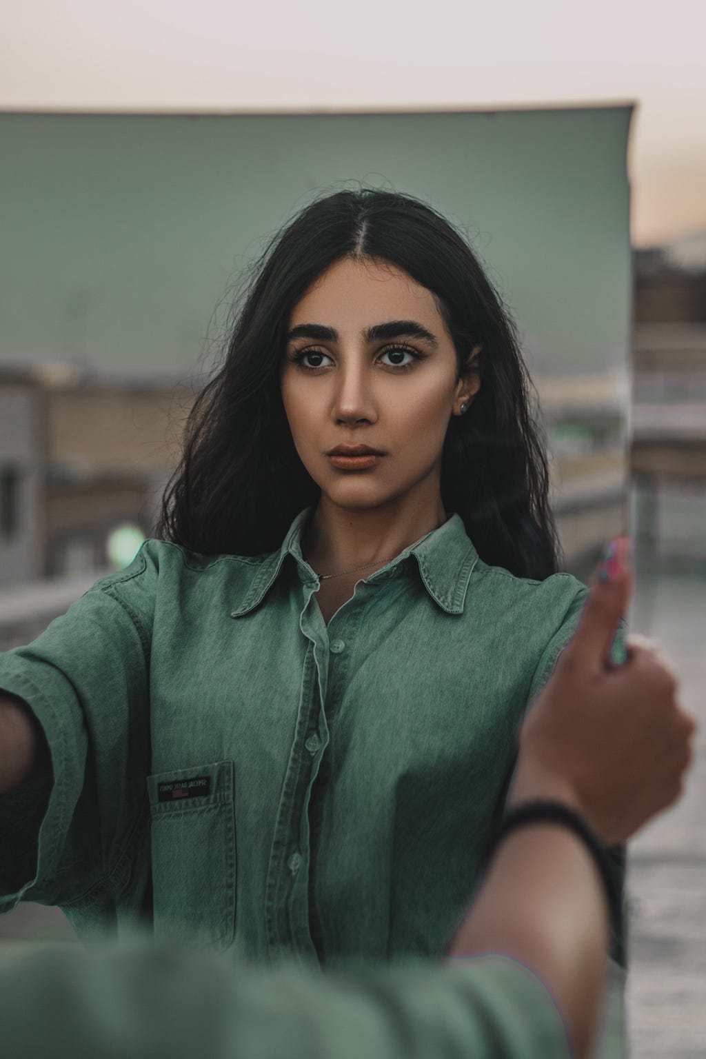 A woman looking in a mirror at herself