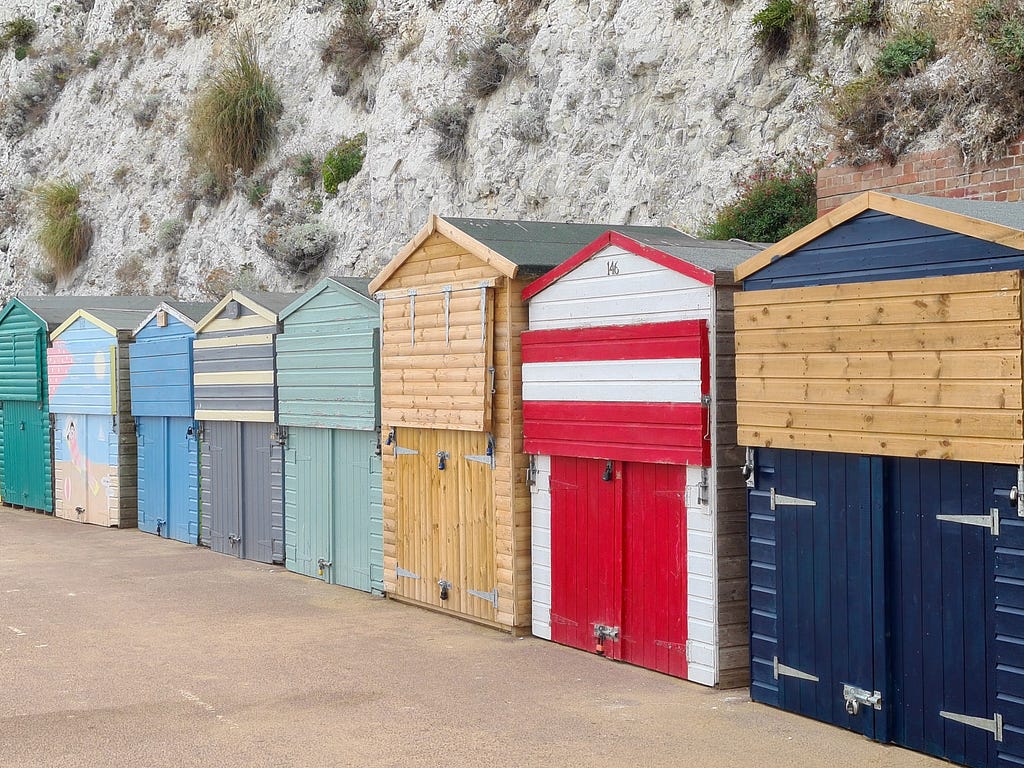 Beach huts in different colourings, but with the same shape