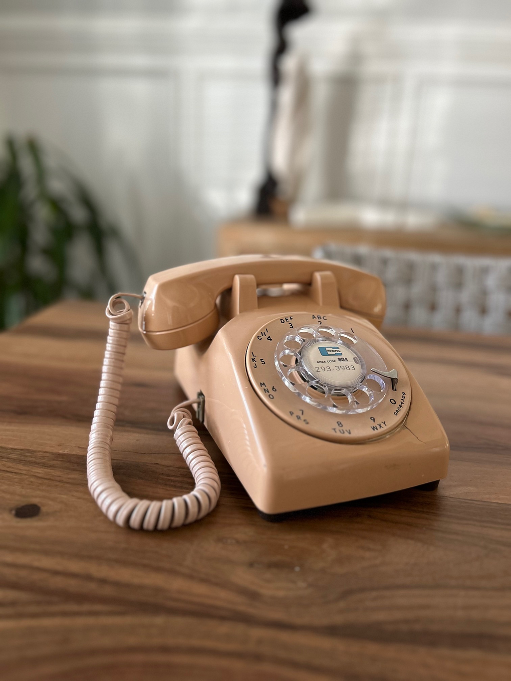 old fashioned rotary telephone on a wood dining table