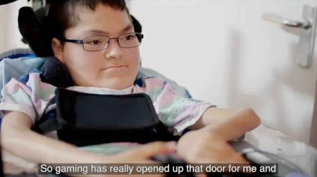 Young disabled gamer from a video shown, with caption ‘So gaming has really opened up that door for me’.