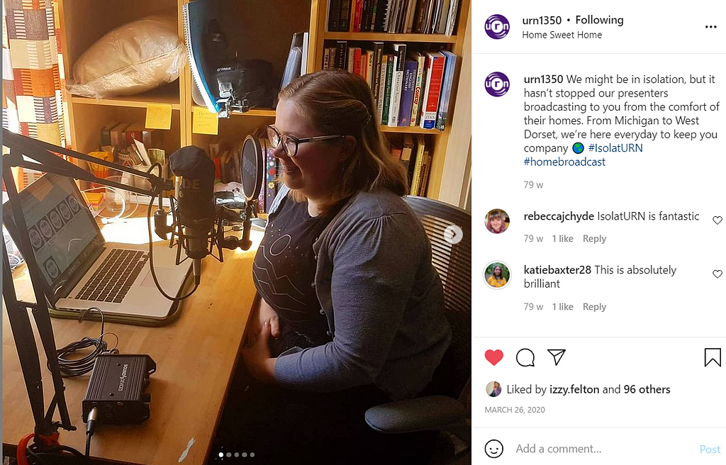 A Girl sits in-front of a microphone with her computer next to her to indicating that she is recording for University Radio Nottingham whose Instagram post it it within.