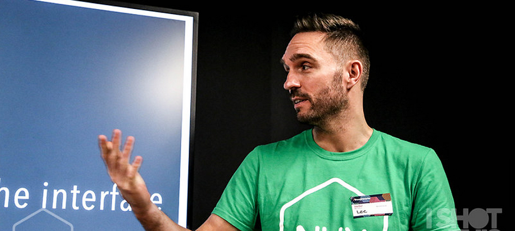 UX Team Lead, Lee Jeffery wearing his NUX t-shirt and introducing one our our speakers at our NUX event in March.