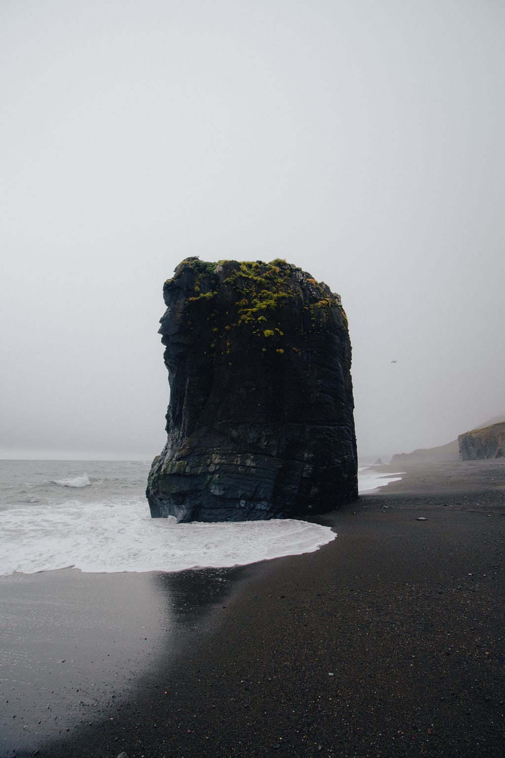 A rock monolith surrounded by the sea.
