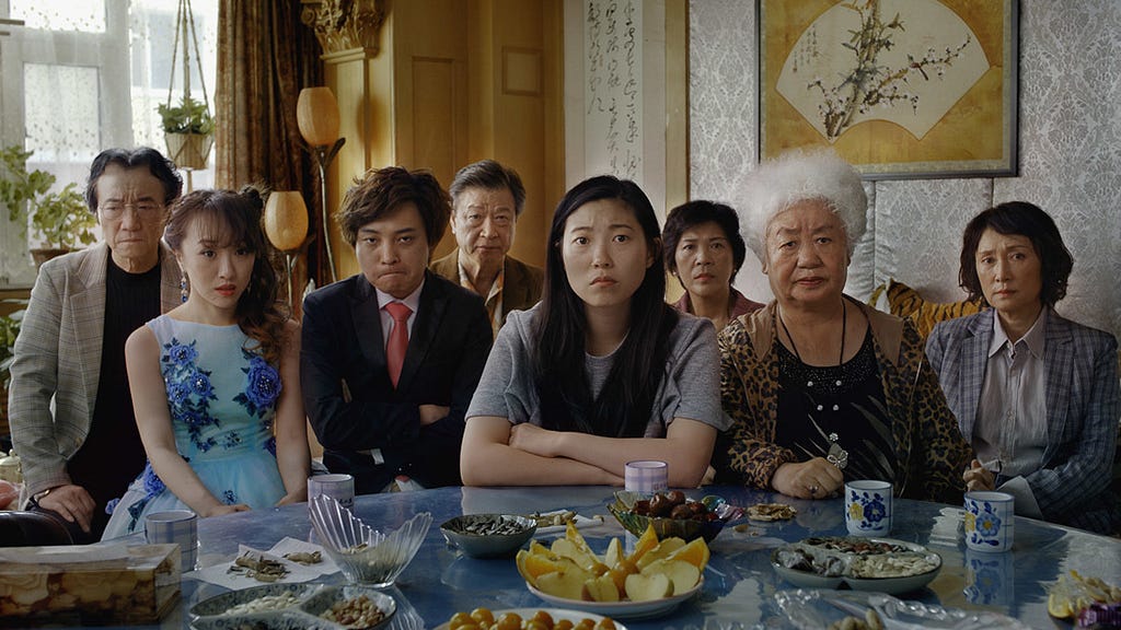 A scene from The Farewell: the family stares towards the camera.