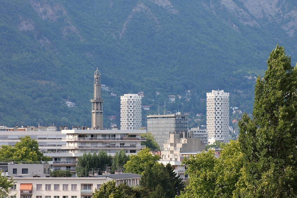 View of the skyline of the city of Grenoble, France, with greenery in the foreground