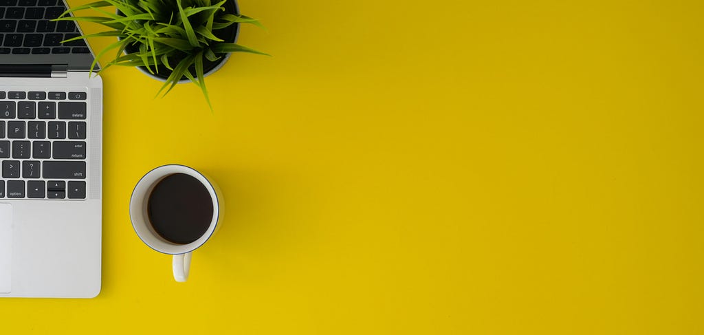 Top View Photo of Coffee Cup on Yellow Surface