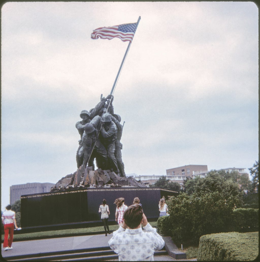 Photograph taken near the front of the Iwo Jima statue in Washington, D.C. in May of 1972, with several of my classmates in the photo: Marty Hanely, Rob Johns (in the foreground with his camera raised), Denise Fowler, Margy Reinbolt, and possibly Linda McGarry and Cathy Ulman — all of whom have their backs to the camera.
