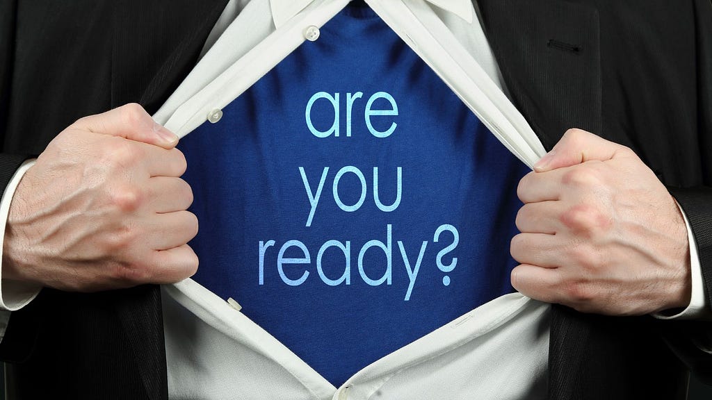 white shirt opening to undershirt reading “are you ready?”