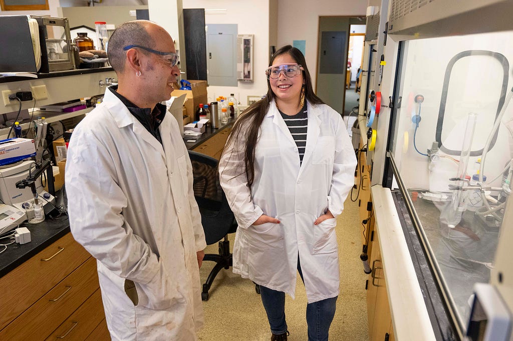 Aaron Thomas, director of UM Indigenous Research and STEM Education, speaks with Ph.D. student Sierra Paske in the Chemistry Building.