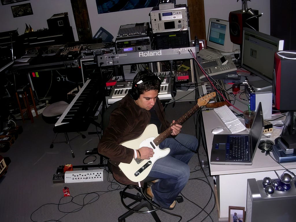 Juan playing guitar at studio Bopnique