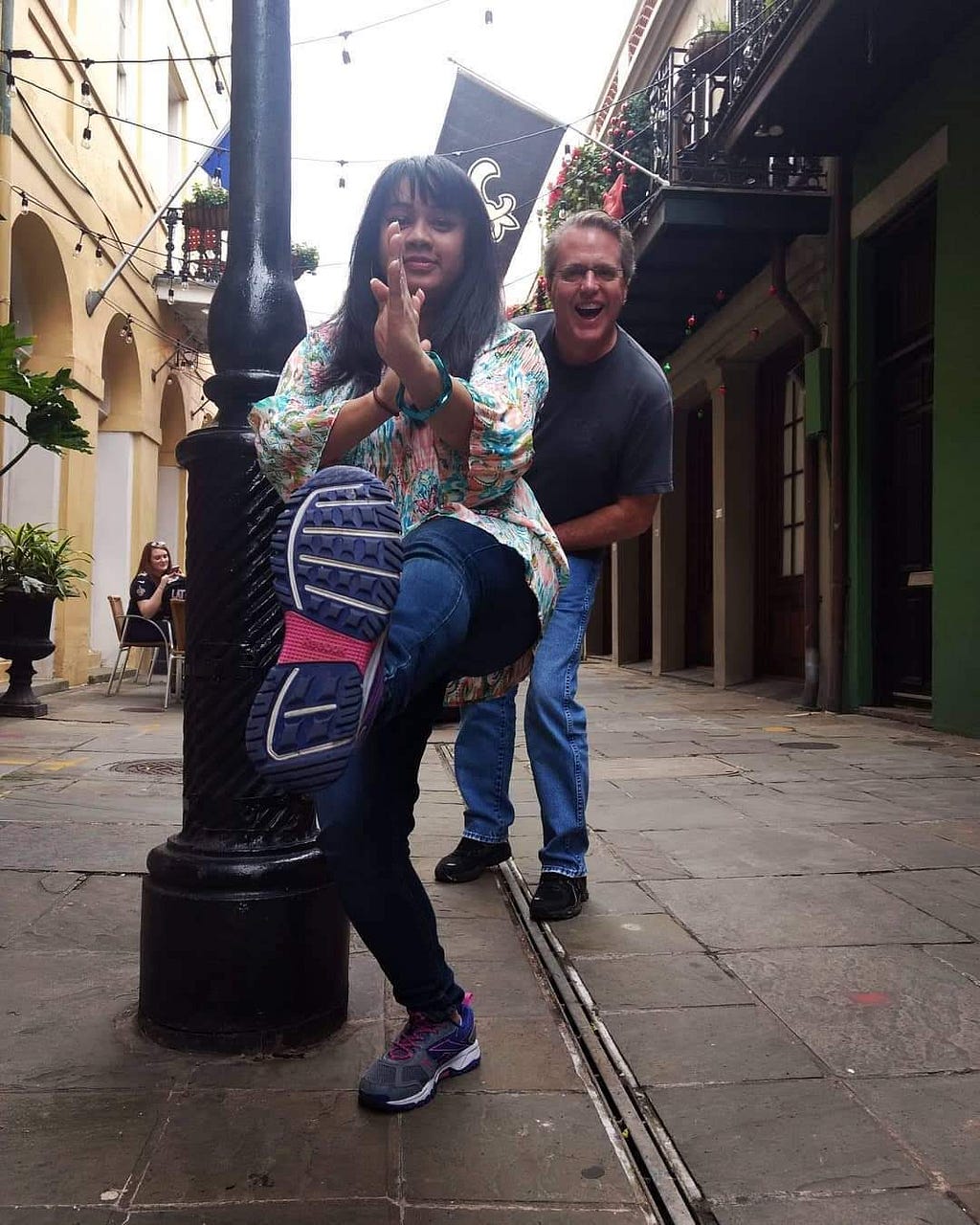 Nandita Gupta posing for a front thrust kick, with her American Dad Eric jumping out behind her. Taken in New Orleans.