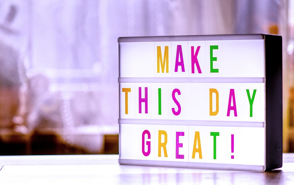 sign on a table saying make this day great