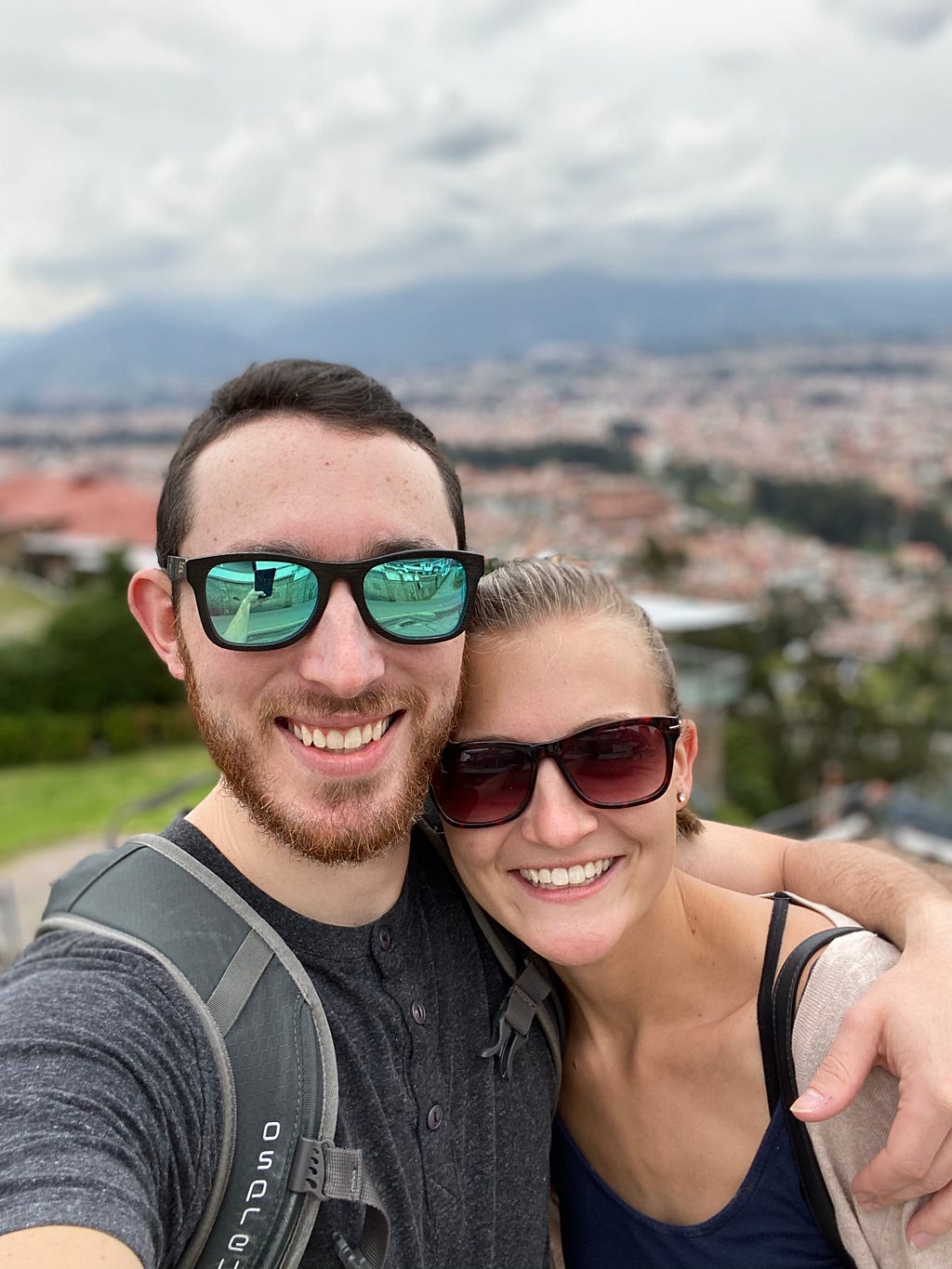The view from Cuenca’s mirador are worth the steep climb! Pictured is a couple with the city of Cuenca sprawled below them.