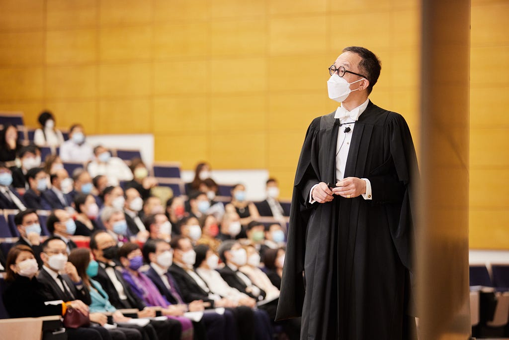 Professor Gabriel Leung delivers a lecture in black academic dress