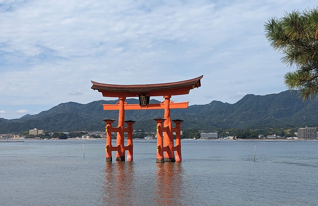 Red torii gate appears to be floating in water at high tide