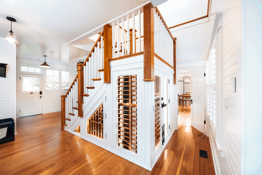 An under the stairs wine cellar blends seamlessly into this circa 1900 farmhouse in Oregon.