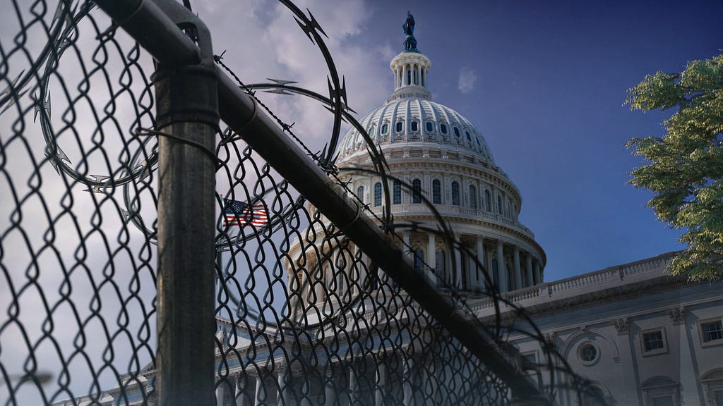 The dome of the U.S. Capitol Building behind a chain-link fence with razor wire. Photo by John Webb/Getty Images