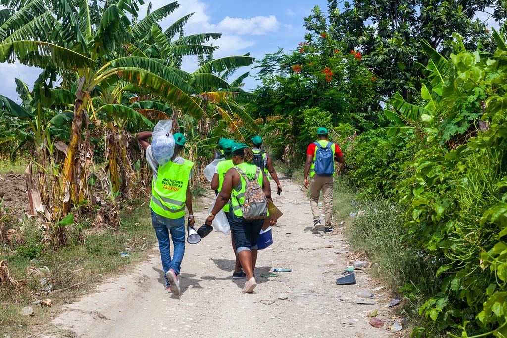 Volunteers travel to farmers’ fields to administer LF medicine during an annual distribution of LF medicine in 2022. Photo credit: RTI International/ Emmanuel Riscka Chery