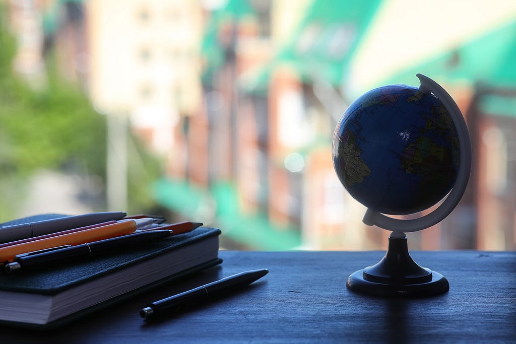 Small globe and notebook.