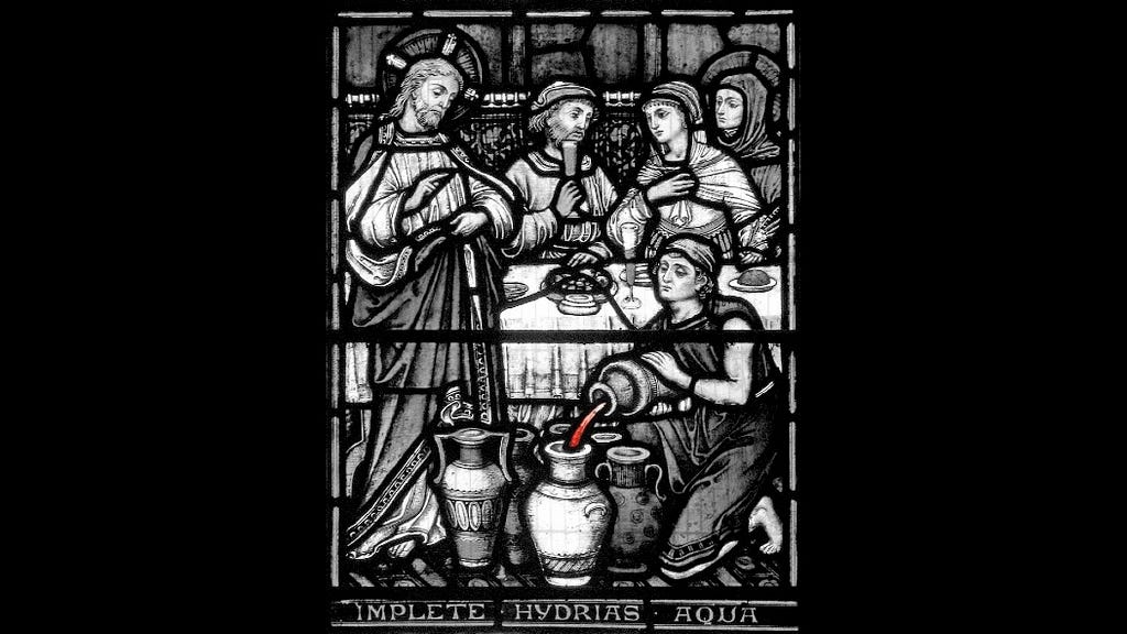 Photo of a stained-glass window depicting Jesus turning water into wine.