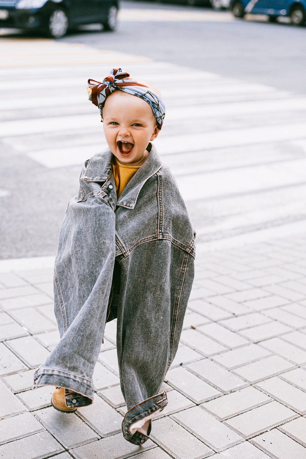 Smilling Baby in an Oversize Denim Jacket