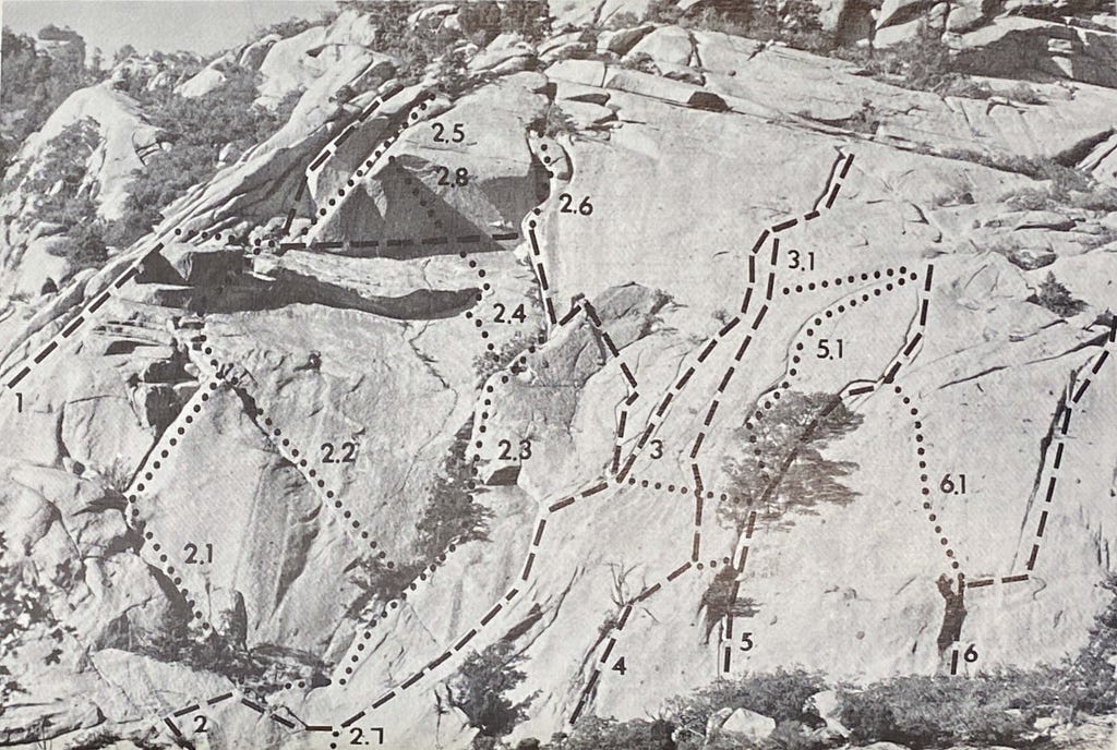 A photograph of a climbing guidebook page, in which a large granite feature is visible with multiple dotted lines indicating different routes up the rock. Each route is identified by a unique number.