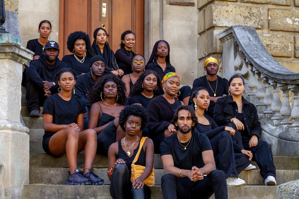 Students from the ACS sit on the steps of the Radcliffe Camera