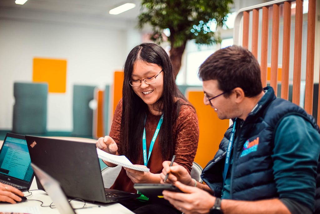 Two people talking and working together