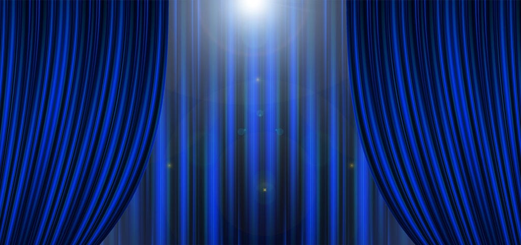 A blue theater curtain, partially open.