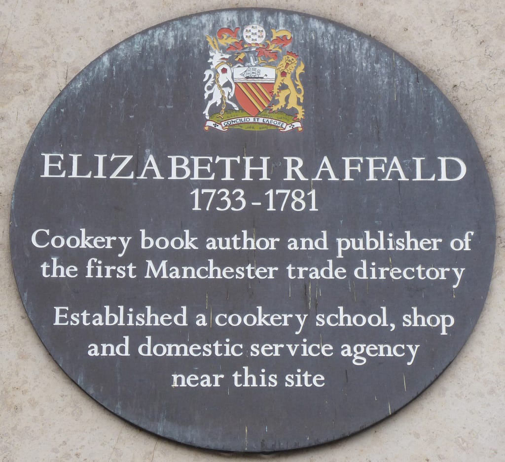 Bronze circular plaque with colourful coat of arms at head and details of Elizabeth Raffald printed in white.