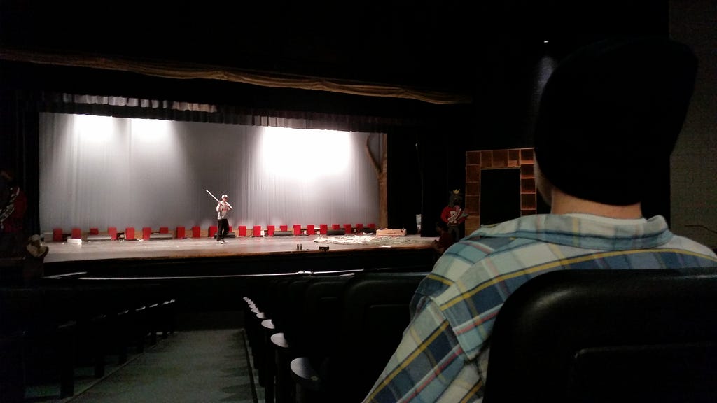 Actor rehearsing on a stage.