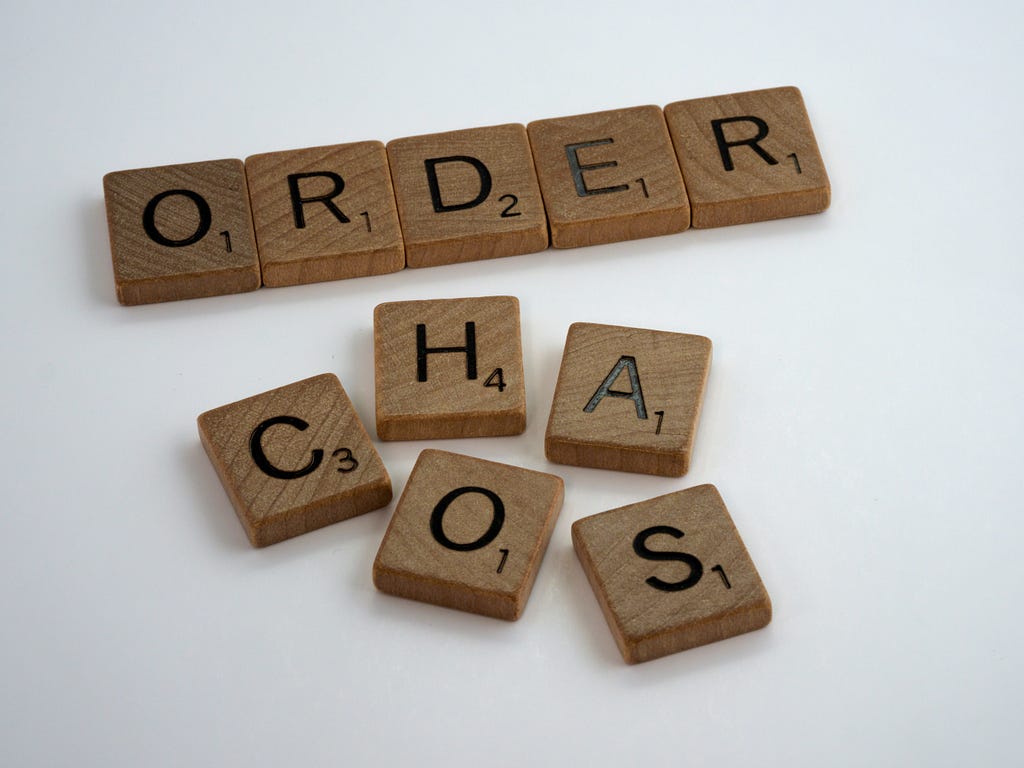 One group of ordered tiles that spells the word “Order.” Below it are five tiles that spell “Chaos” but are jumbled up.